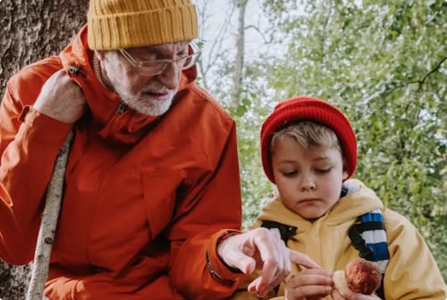 A grandfather and grandon in the forest